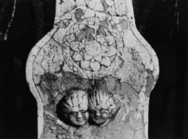Le registre supérieur du fût est décoré de deux têtes d'angelots ailées, ainsi que d'un motif floral (photographie du service régional de l'inventaire de Lorraine).