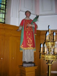 La statue de saint Étienne, représenté portant sa dalmatique de diacre et tenant la palme du martyre, se situe à gauche du maître-autel.
